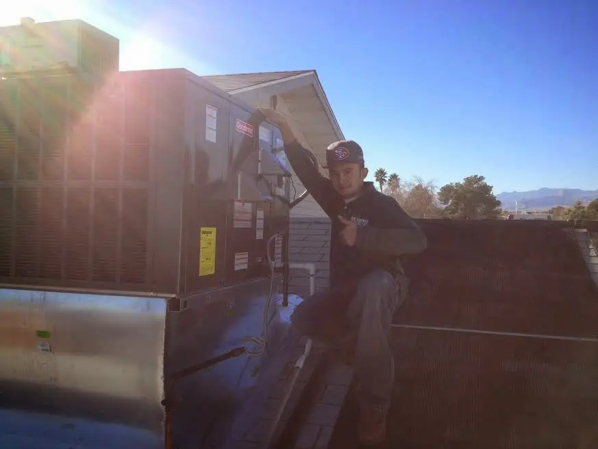 HVAC technician performing AC Tune-Up on a rooftop unit in Vero Lake Estates